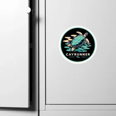 Cayrunner Turtle Drift flexible magnet on a white refrigerator door, next to the handle and seam.