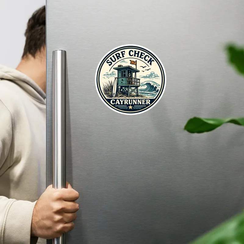 Cayrunner Surf Check flexible magnet on a stainless steel fridge, with a person opening the door beside it.