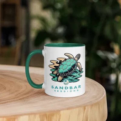 Cayrunner Sea Turtle Drift coffee mug with green handle, Sandbar Sessions branding, displayed on a wooden table.