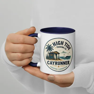 Cayrunner High Tide Trading Co. coffee mug held in hand, showing the vintage surf shop badge design.