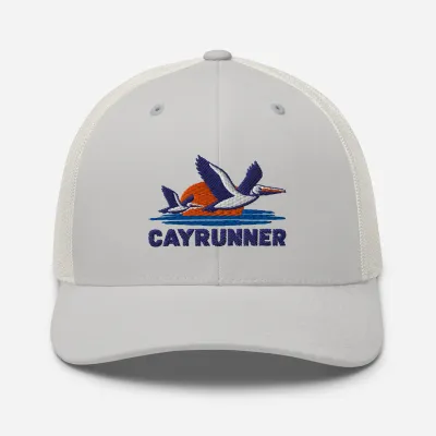 Cayrunner Pelicans Over Coastal Sun Trucker Cap in silver gray with embroidered pelicans, sunset, waves, and Cayrunner text