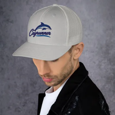 Man in a black jacket wearing the silver gray Leaping Dolphin Cayrunner Logo Trucker Cap with embroidered dolphin logo
