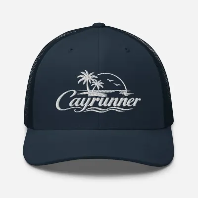 Cayrunner Logo Trucker Cap in navy with white embroidered palm trees, sunset, seabirds, waves, and script Cayrunner text