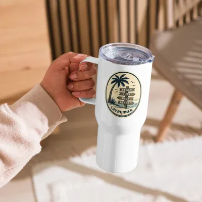 Cayrunner Vintage Coastal Surf Sign Travel Mug with Handle, held by the handle in a sunlit room