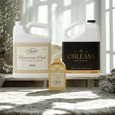 Luxury laundry detergent bottles from Tyler and Orleans — fine wash and scented sachets styled in an elegant home setting