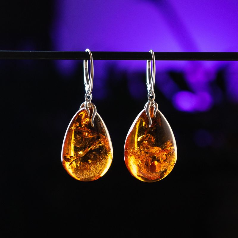 Drop shape flame speckled amber earrings