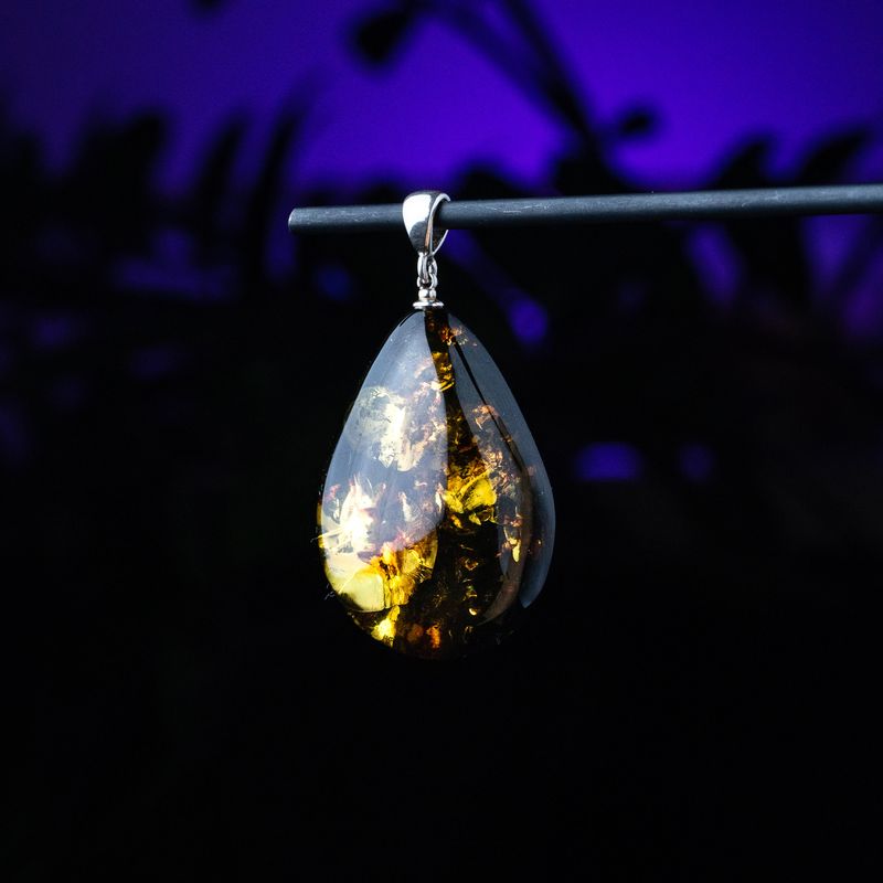 Medium black/yellow speckled drop shape amber pendant