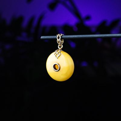 Ornate small donut shape butterscotch amber pendant