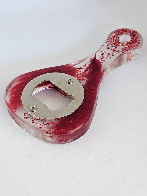 Heart-shaped resin bottle opener with red feathers and glitter