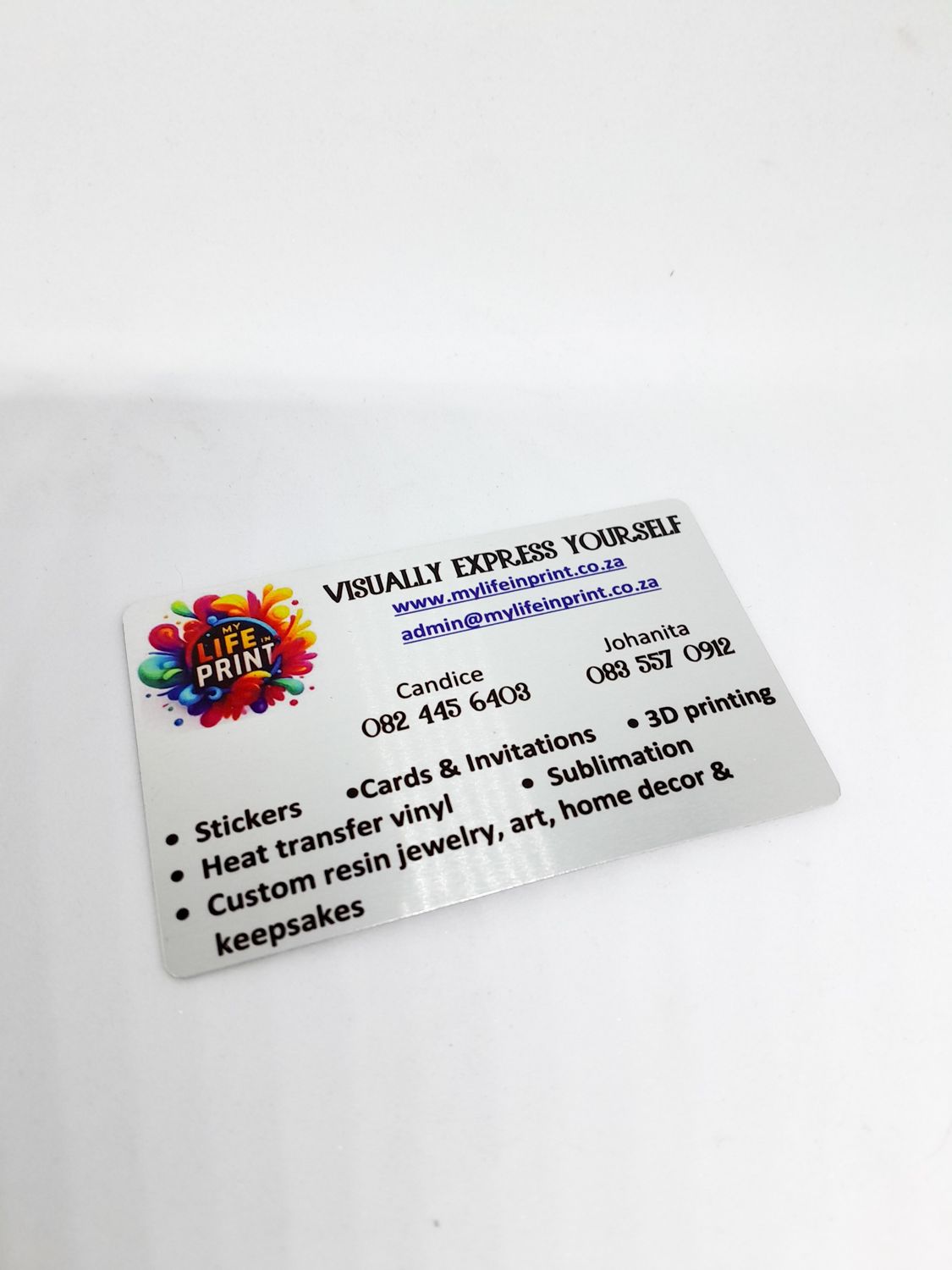 Aluminium business card with My Life in Print logo and contact details on a white background