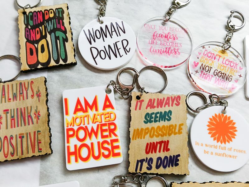 Custom printed keychains in round, rectangle, and wood-style shapes. Suitable for business branding, names, and gifts.