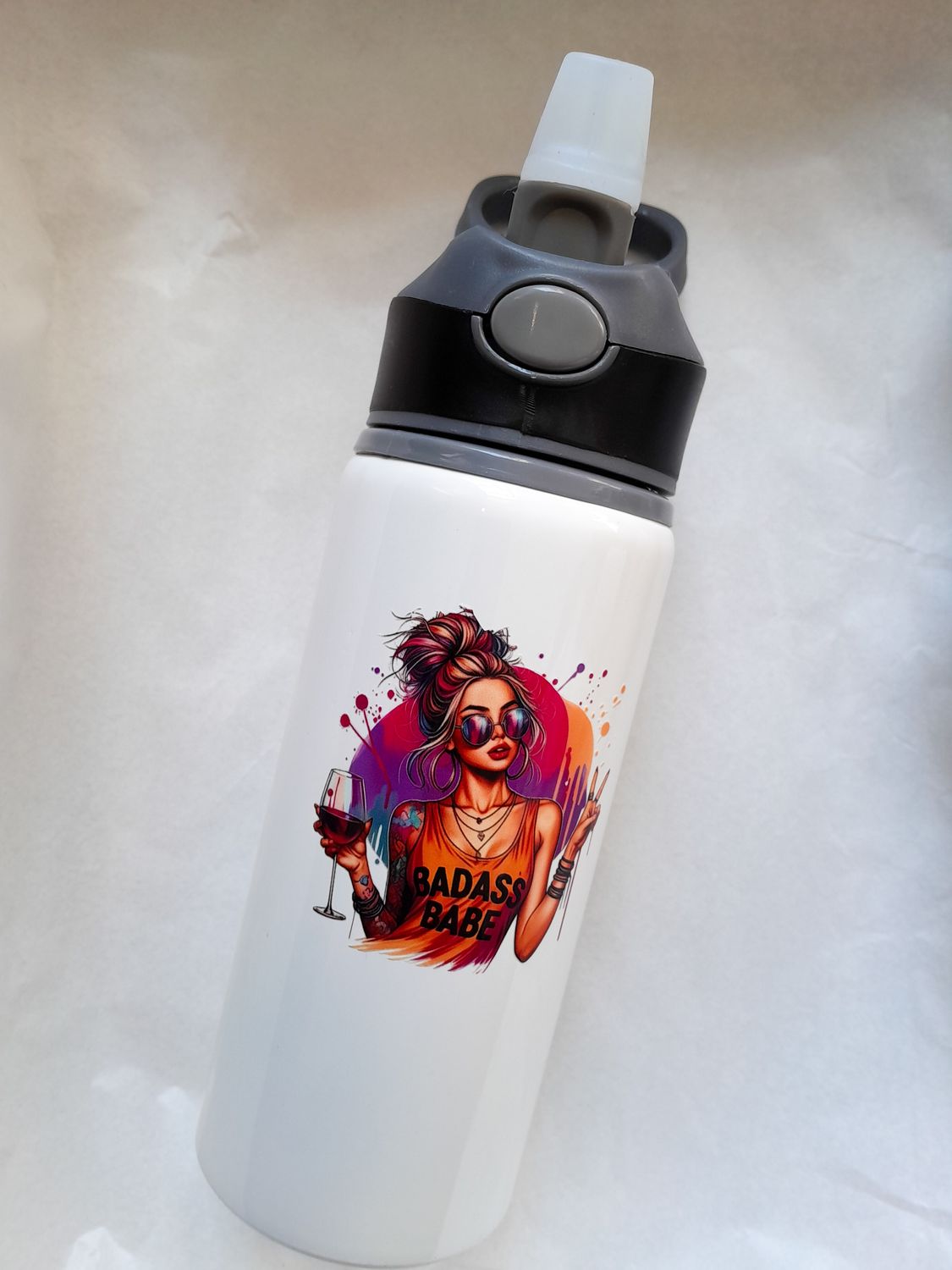 White 600ml sublimation water bottle with flip straw lid, featuring a printed “Badass Babe” design holding a wine glass.