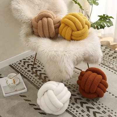 Knotted wool ball pillow