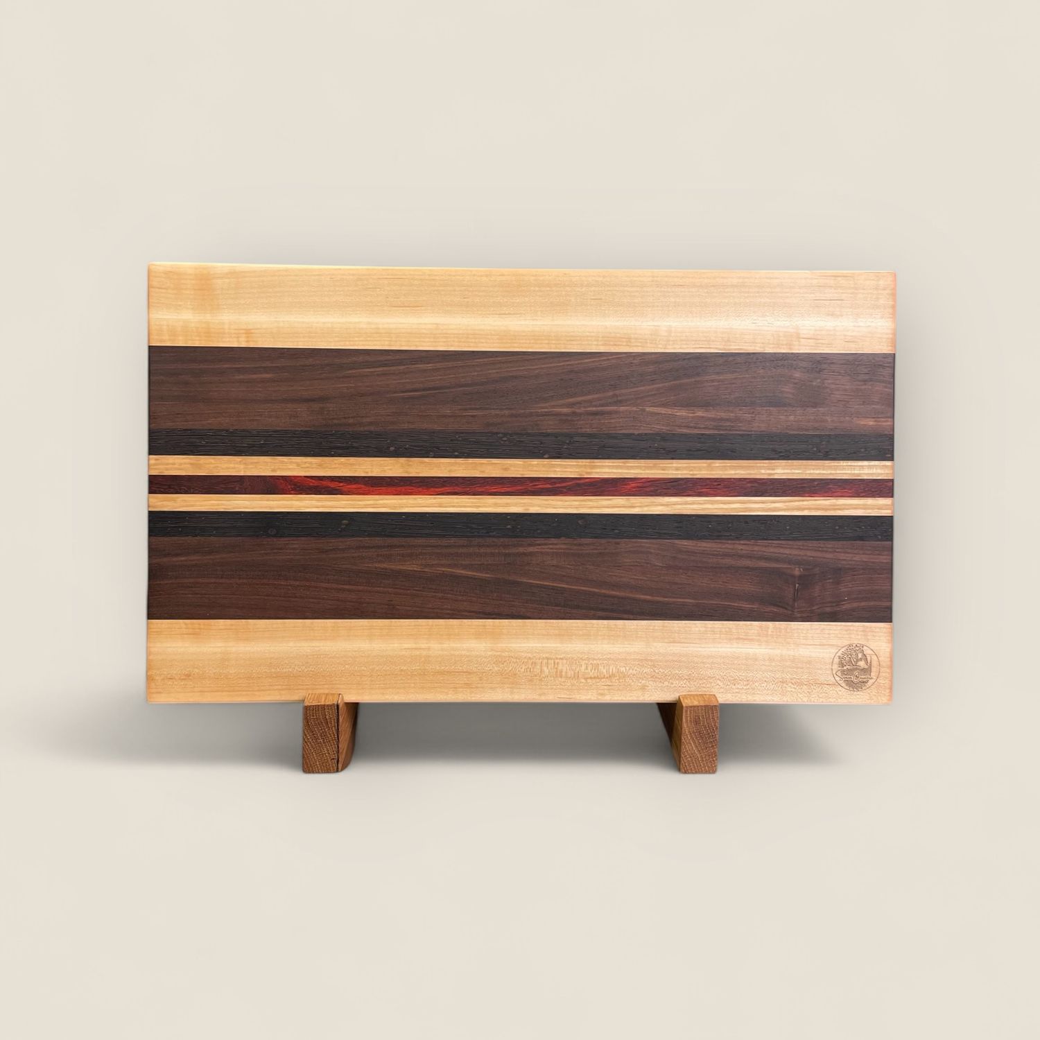 Planche à découper en bois d'Érable, Noyer, Wengé et Padauk (bois exotique). Fait en côtés de planches (edge grain). Avec pieds en Inox.