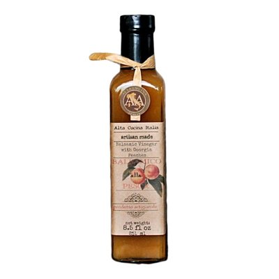 Alta Cucina bottle of peach-infused balsamic vinegar with beige label and black cap