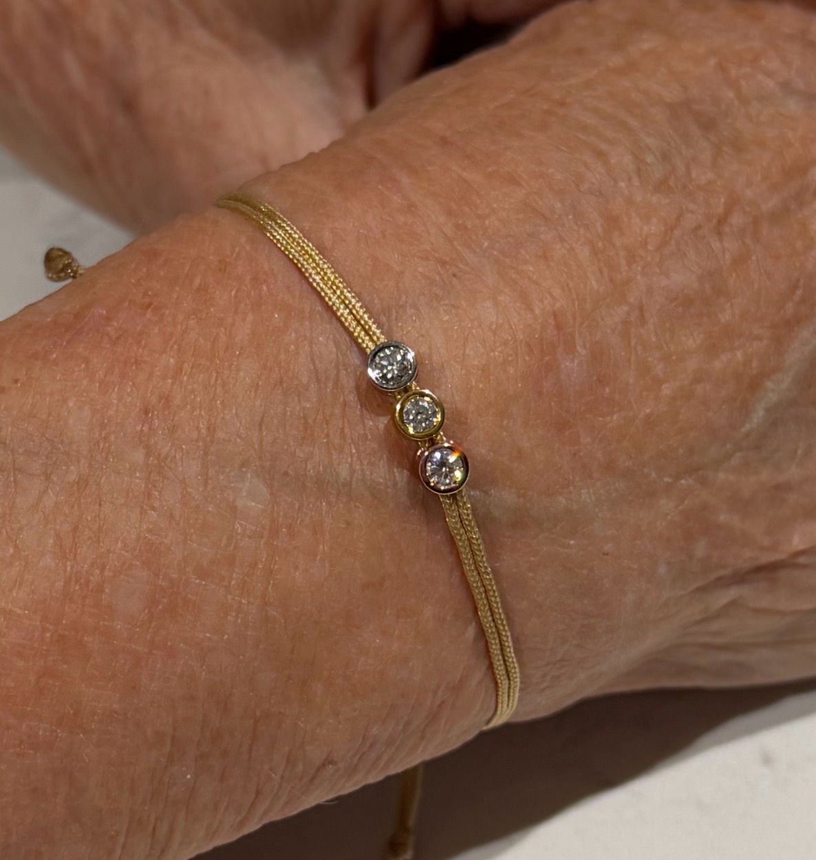 Love Lab Triple 0.10ct Round Brilliant Cut Lab-Grown Diamond Gold-Nylon Cord Bracelet - Tricolour Setting Love Lab Triple 0.10ct Round Brilliant Cut Lab-Grown Diamond Gold-Nylon Cord Bracelet - Tricolour Setting