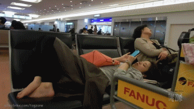 Japanese Feet Up on Suitcase, Down on Seat