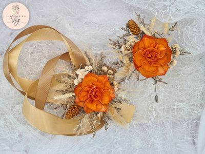 Handcrafted orange dahlia sola wood corsage and boutonniere set featuring dried flowers like gypsophila and caspia, gold satin ribbons. Eco-friendly, long-lasting floral accessories for weddings and proms.