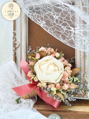 Handcrafted Sola Wood Rose Wrist Corsage and Boutonniere Set with white roses, gypsophila, and statice. Features dark pink satin ribbon and rustic jute string. Ideal for weddings and proms