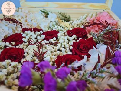 Elegant pinewood box featuring 8 preserved red roses in a heart shape, surrounded by hydrangea, ferns, gypsophila, statice, and caspia. Decorative beads add luxury. Perfect for anniversaries, Valentine&#39;s Day, and weddings.