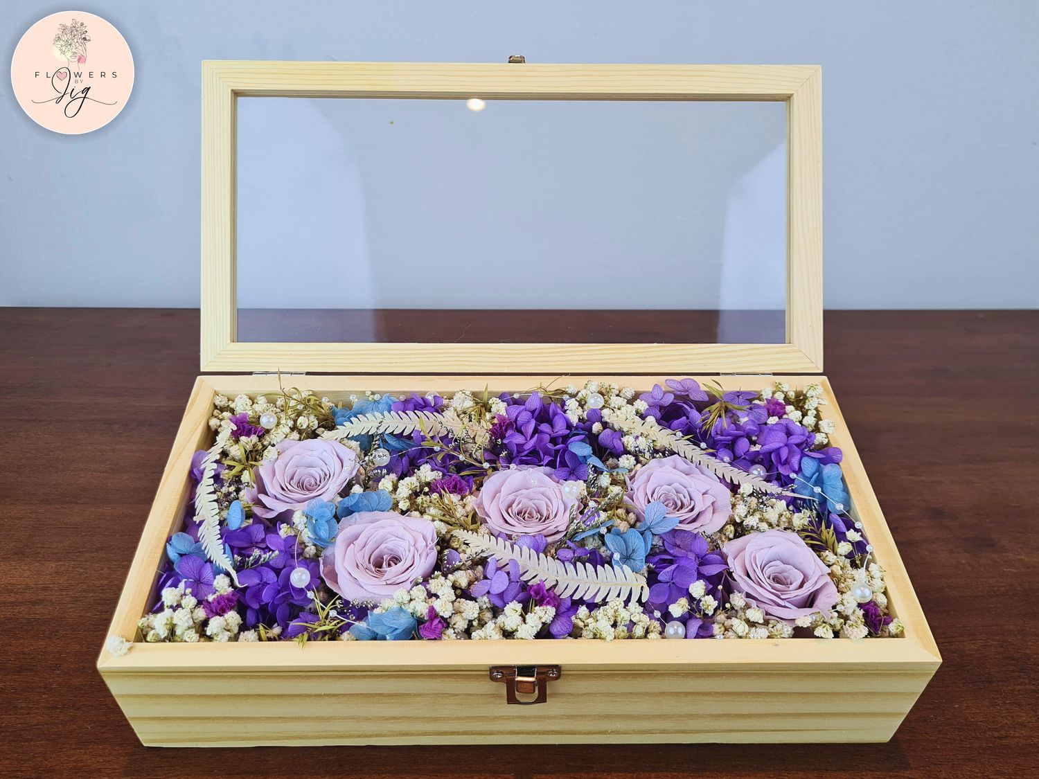 Elegant Pinewood Box with 5 Purple Infinity Roses, preserved for lasting beauty. Includes hydrangea, ferns, gypsophila, statice, caspia, and decorative beads. Perfect gift for anniversaries, weddings, or home decor. Sustainable and luxurious.