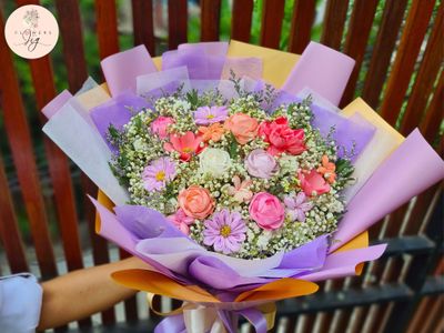 Elegant Sola Wood Floral Arrangement: This Blooming Bouquet blends handcrafted sola wood roses, daisies, &amp; jasmine with dried gypsophila. Ideal for weddings, birthdays, and more. Wrapped in colorful paper, it offers a bouquet that will last for years