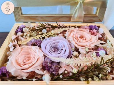 Glass Box Bouquet featuring 2 Champagne Infinity Roses and 1 Vintage Purple Infinity Rose. Dried flowers, ferns, and decorative pearls included. Ideal for weddings, anniversaries, and birthdays. Encased in a handmade Pinewood Box
