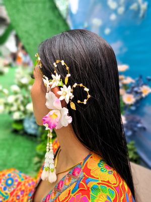 Handmade white and pink Cattleya orchid ear wrap featuring gold flair, crystal diamonds, and pearl beads. Ideal for high fashion and weddings, this unique accessory offers a realistic floral design and luxurious sparkle for any formal occasion.