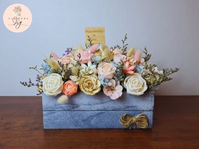 A beautifully arranged Artificial Flower Box featuring a mix of multi-colored faux roses