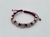 St Benedict red slip knot bracelet with silver tone medals