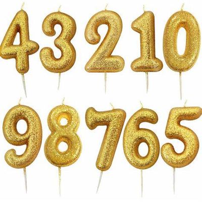 VELA GLITER ORO CON 10 NUMEROS SURTIDOS