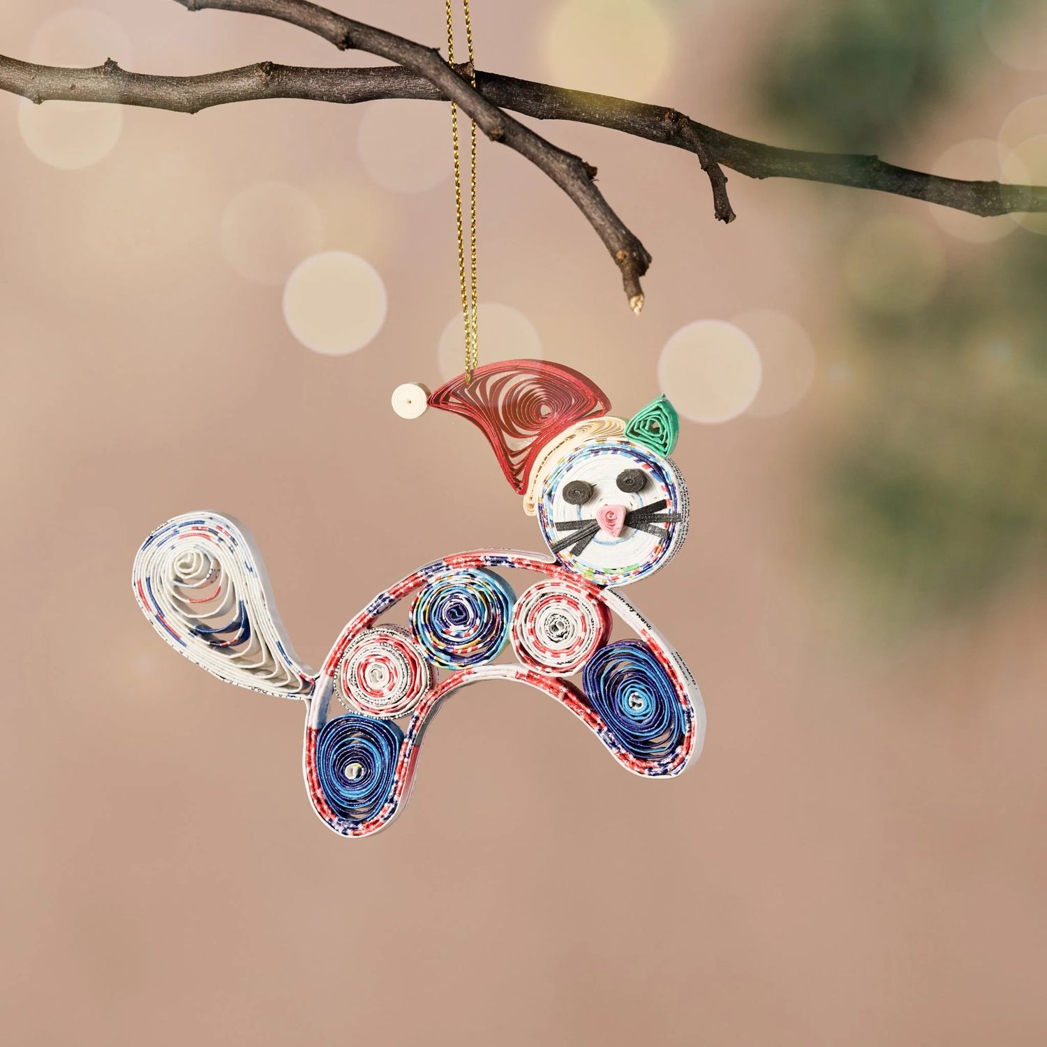 Recycled Paper Cat Ornament features multicolored paper and red stocking cap.