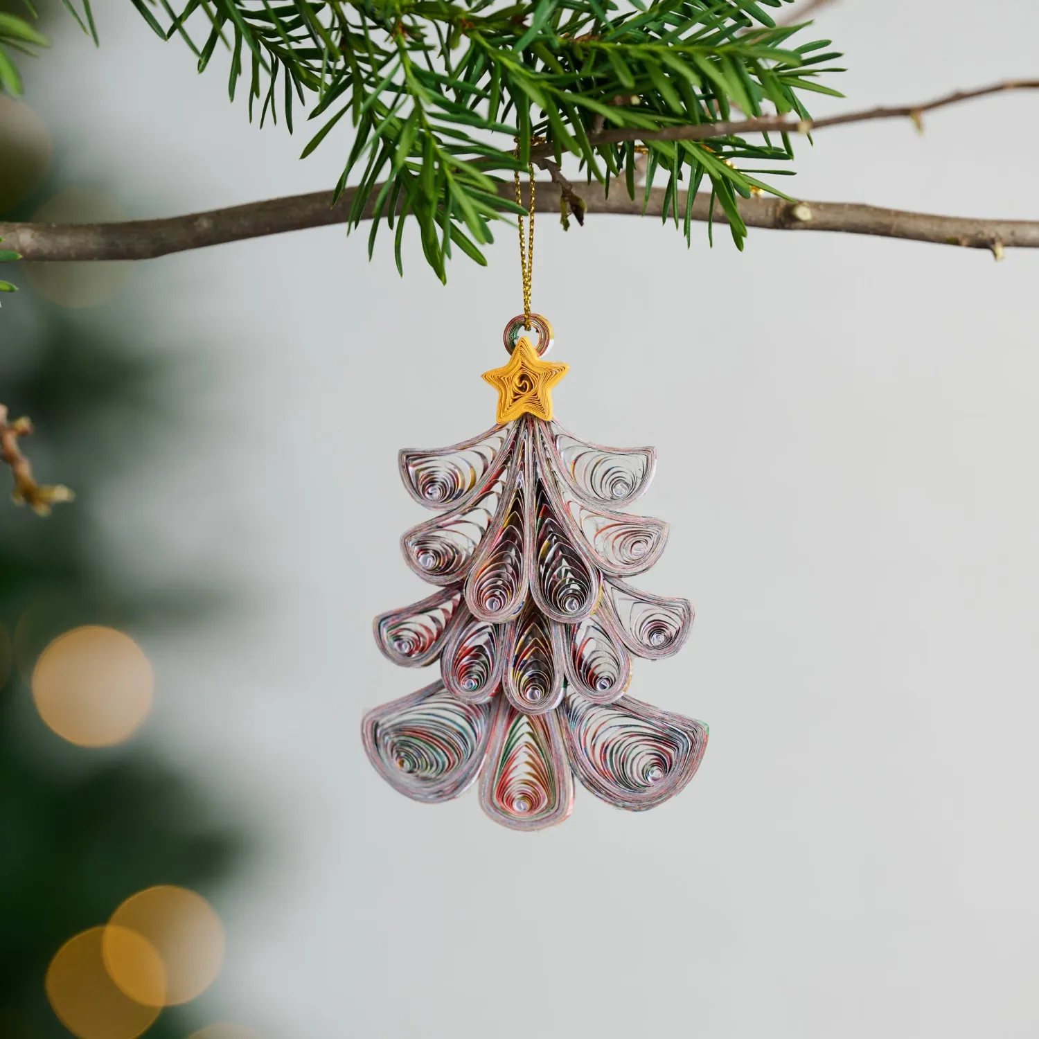 Recycled Paper Quilled Tree Ornament features recycled magazine pages and yellow star.