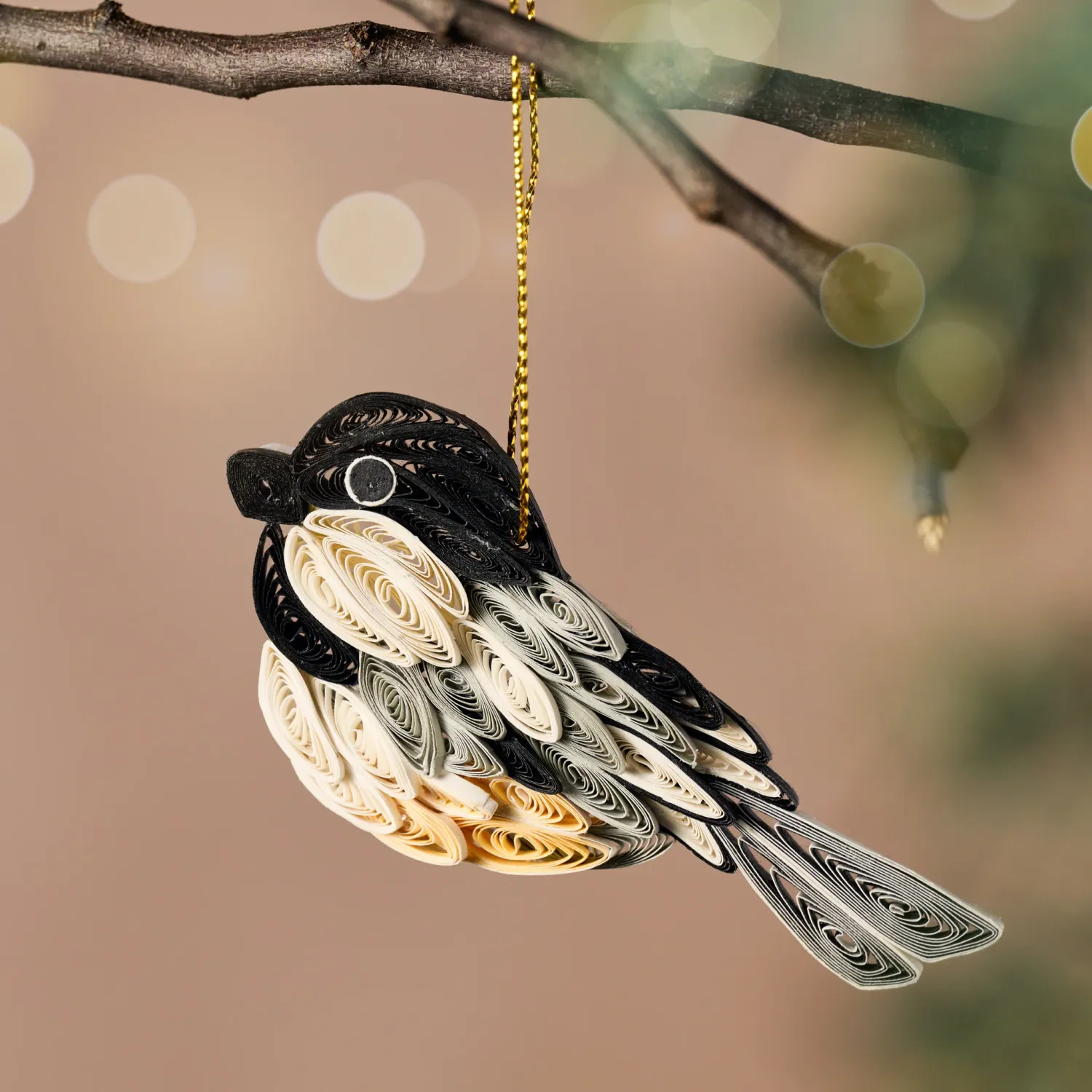 Quilled paper chickadee ornament is black, white and tan in color.