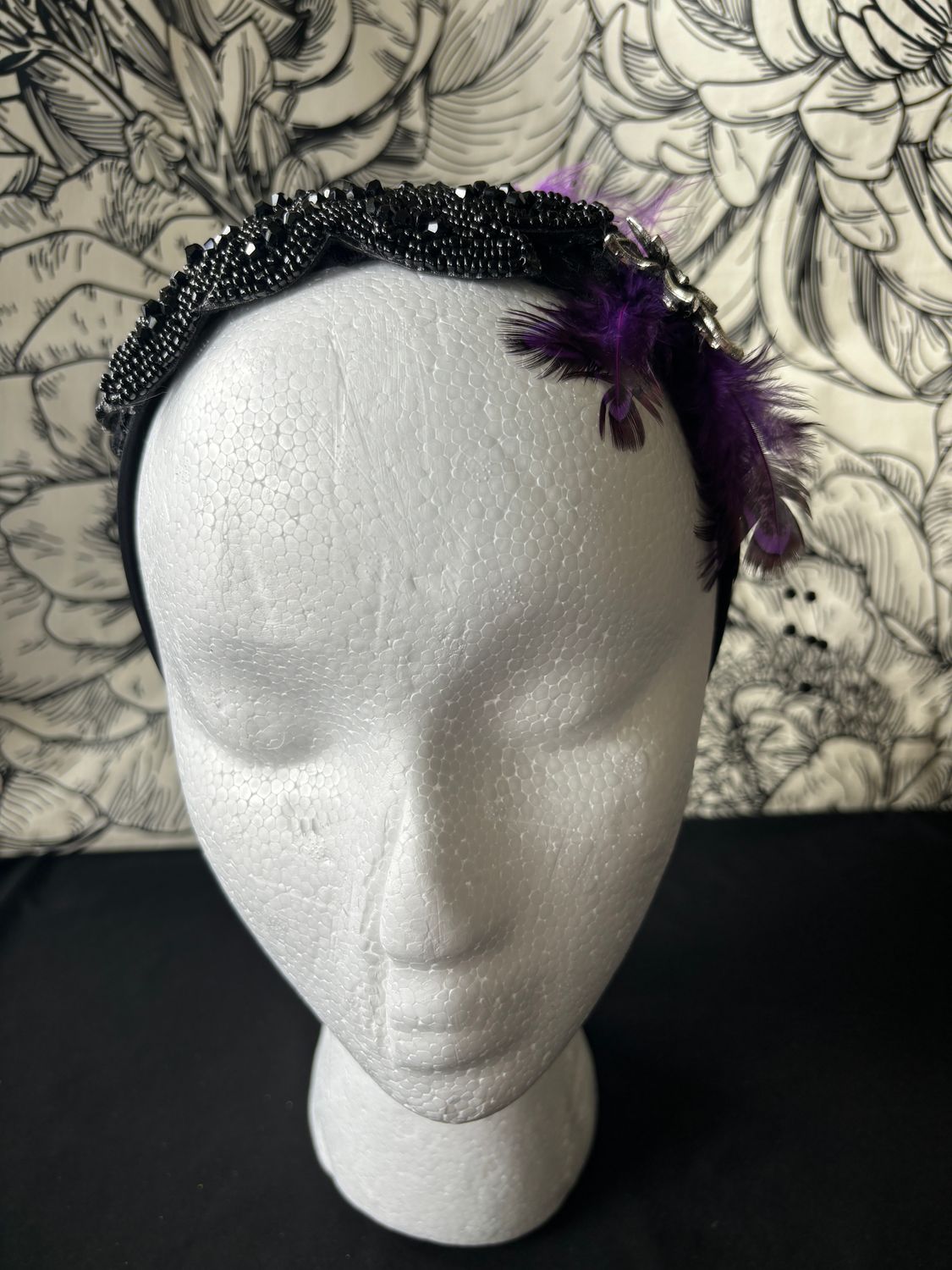 Purple feathers, metal flower, black band