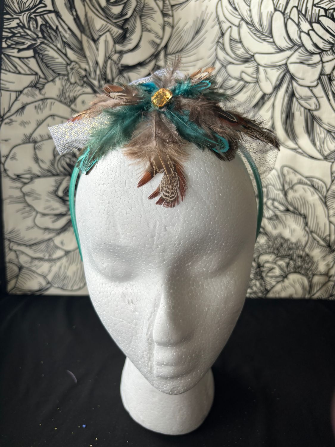 Brown and teal feathers yellow gem on teal band
