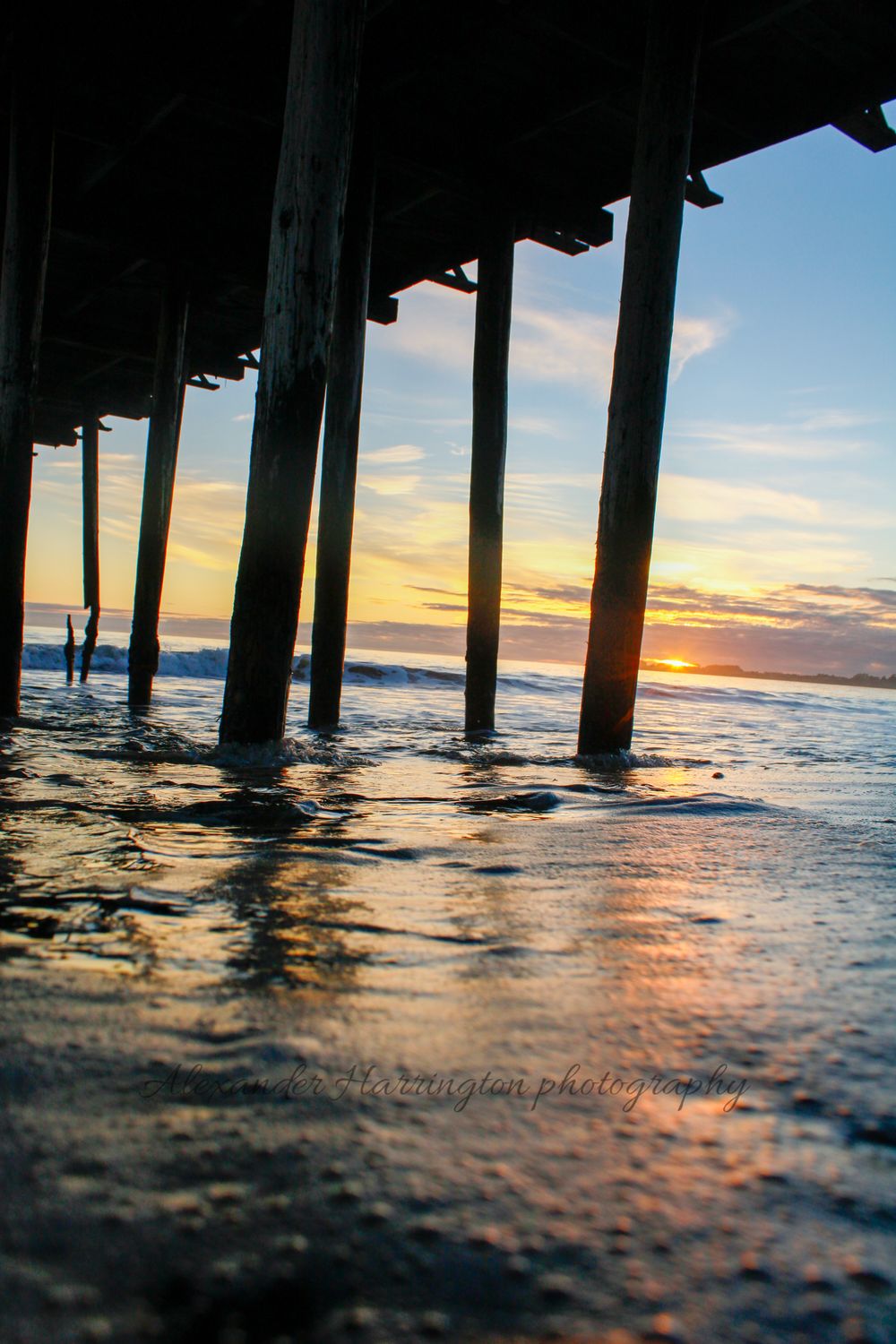 Under the USS Palo Alto pier at sunset, low angle on the water