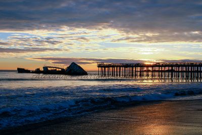 USS Palo Alto with pier at sunset, cool color, wide angle