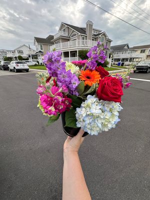 A colorful vase of flowers delivered to cape may county nj barrier islands featuring hydrangeas, gerbera daisies, and roses