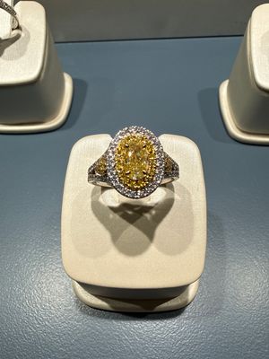18k White and Yellow Gold .82ct Yellow Diamond Oval Halo Ring. 1.7ctw