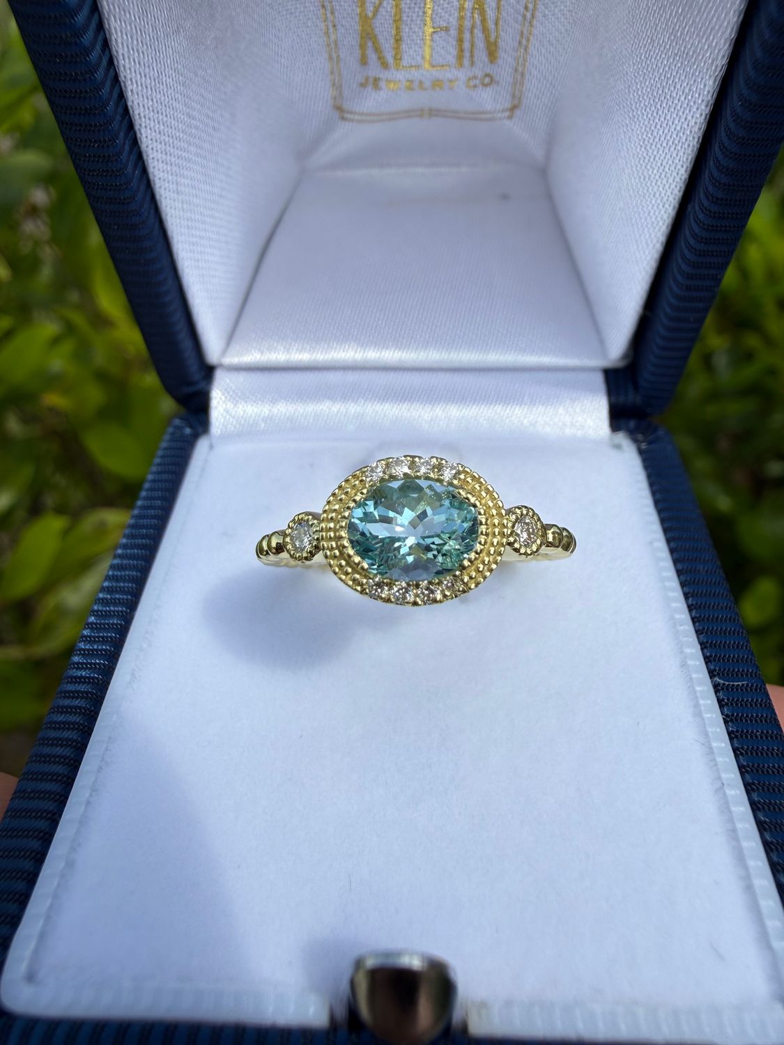 14k Green Gold Aqua Marine Ring accented with Milgrane and Diamonds with a bead style Shank. Dia:0.05ctw
