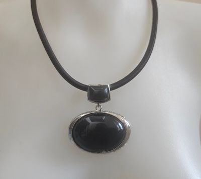 Sleek black acrylic pendant necklace with a modern, bold charm