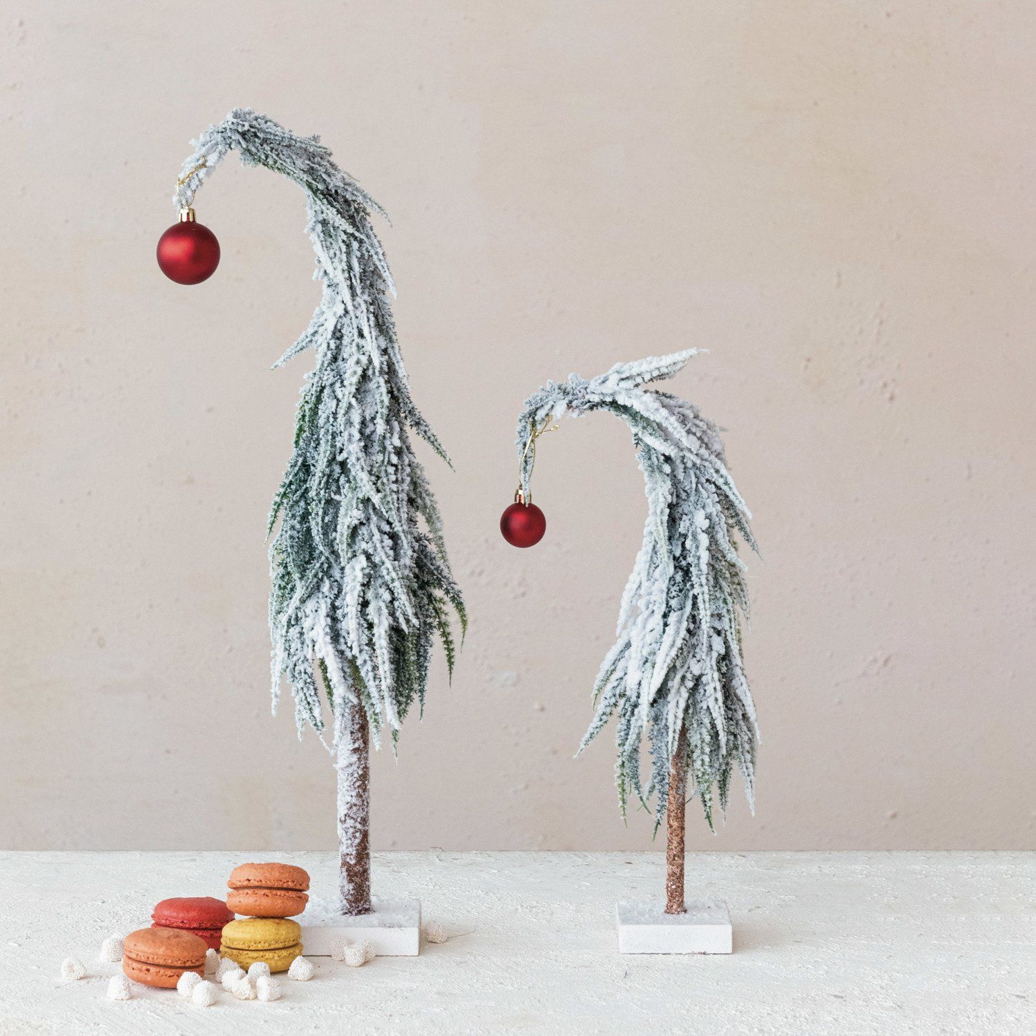 Leaning Evergreen Tree with Red Ball Topper