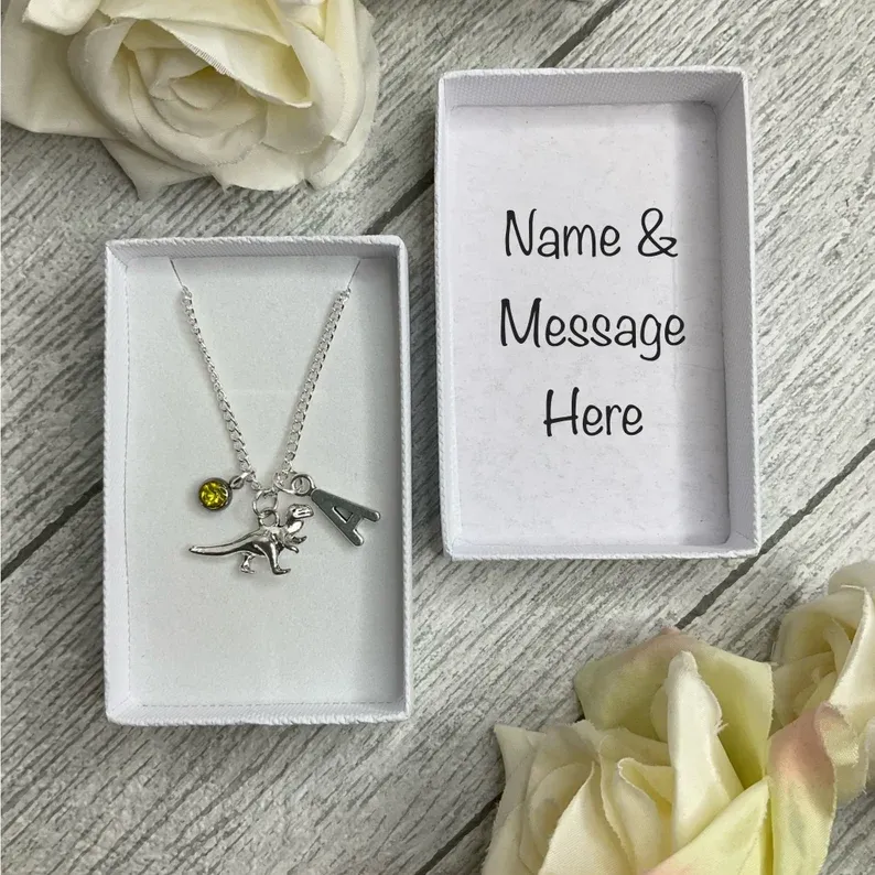 Dinosaur necklace with a dinosaur charm, birthstone and initial charms