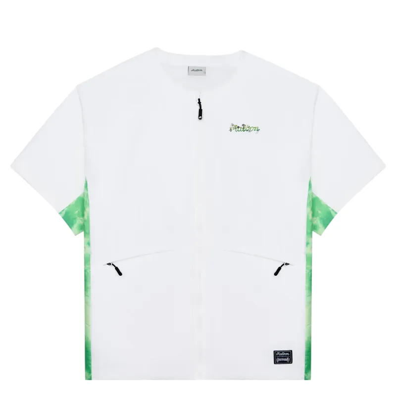 Front view of Malbon Golf Grateful Dead Underwood Windshirt in white with green artwork and zip pockets.