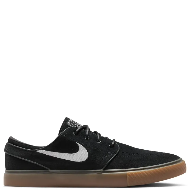 Side view of Nike SB Zoom Janoski OG+ skate shoe in black suede with white Swoosh and gum outsole.