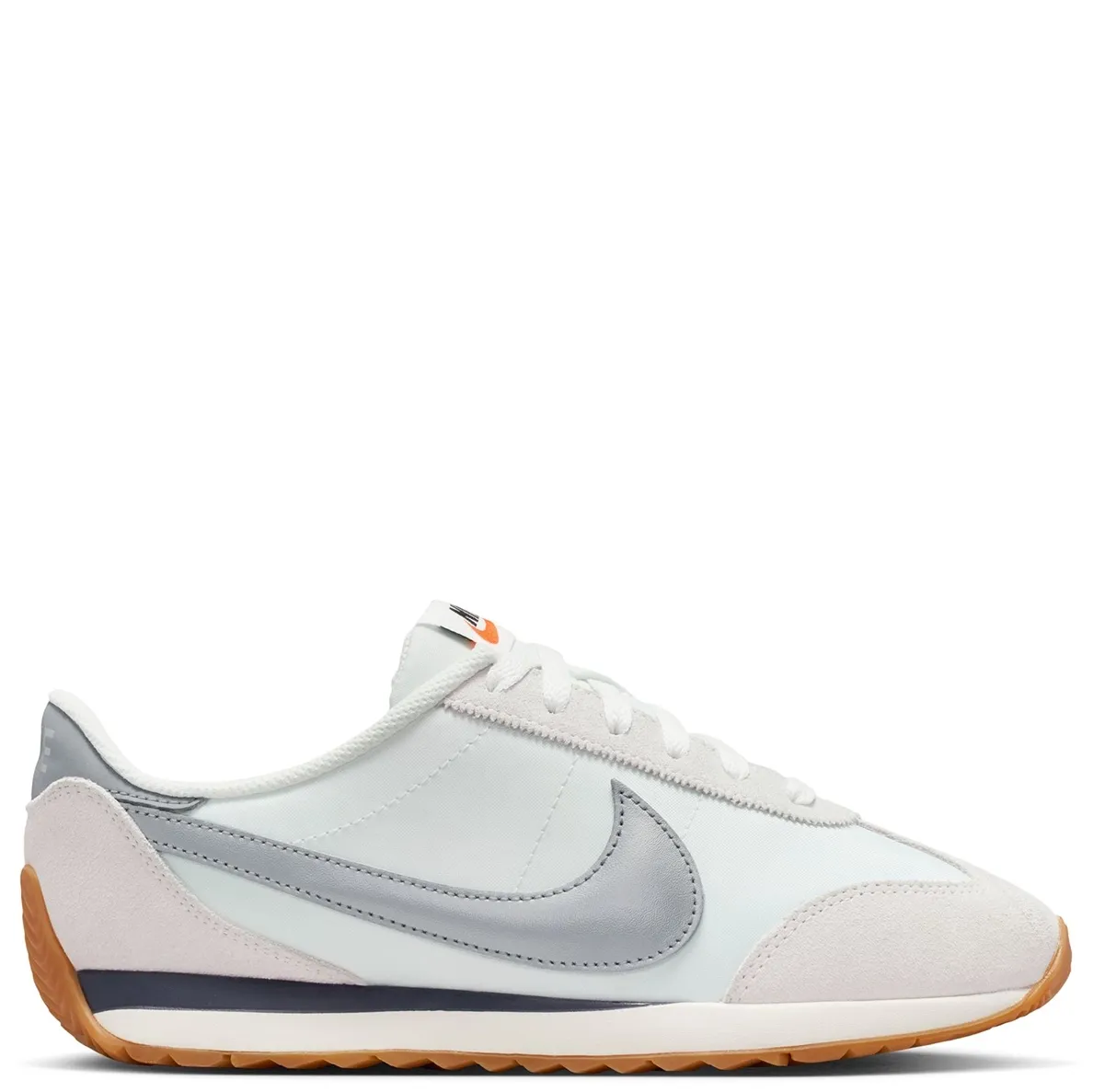 Lateral side view of Nike Women’s Pacific Sail sneaker featuring puffed Metallic Silver Swoosh and layered suede overlays.