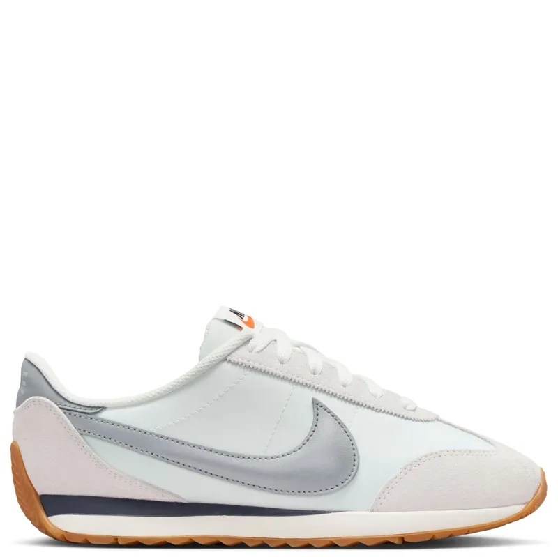 Lateral side view of Nike Women’s Pacific Sail sneaker featuring puffed Metallic Silver Swoosh and layered suede overlays.
