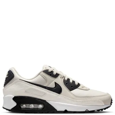 Lateral side view of Nike Women’s Air Max 90 Sail Black Phantom sneaker with black Swoosh and visible Air cushioning.