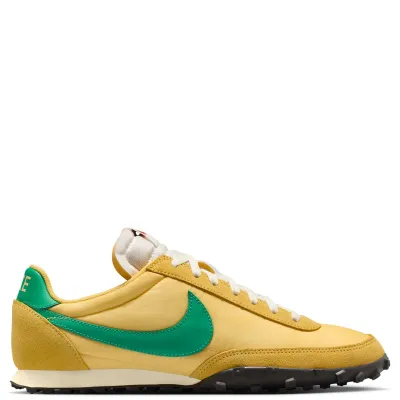 Lateral side view of Nike Waffle Racer in Topaz Gold featuring green leather Swoosh, suede mudguard, and low-profile midsole.
